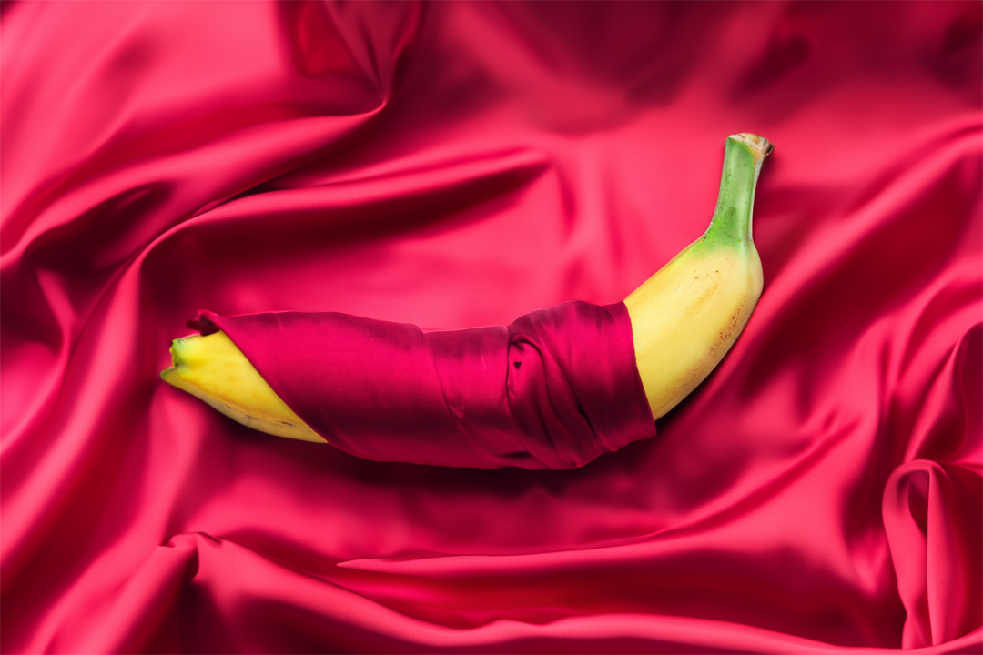 Wrapped In Luxury A banana is wrapped in red silk.