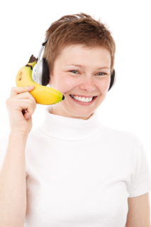 Bananas Nana A photo of a person holding a banana phone while wearing headphones, smiling, and depicted like a call center representative.