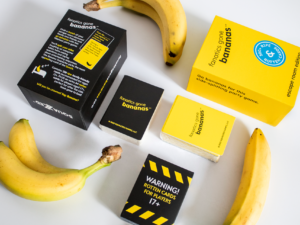 A flat lay style photograph of the Fanatics Gone Bananas box and contents, surrounded by bananas.
