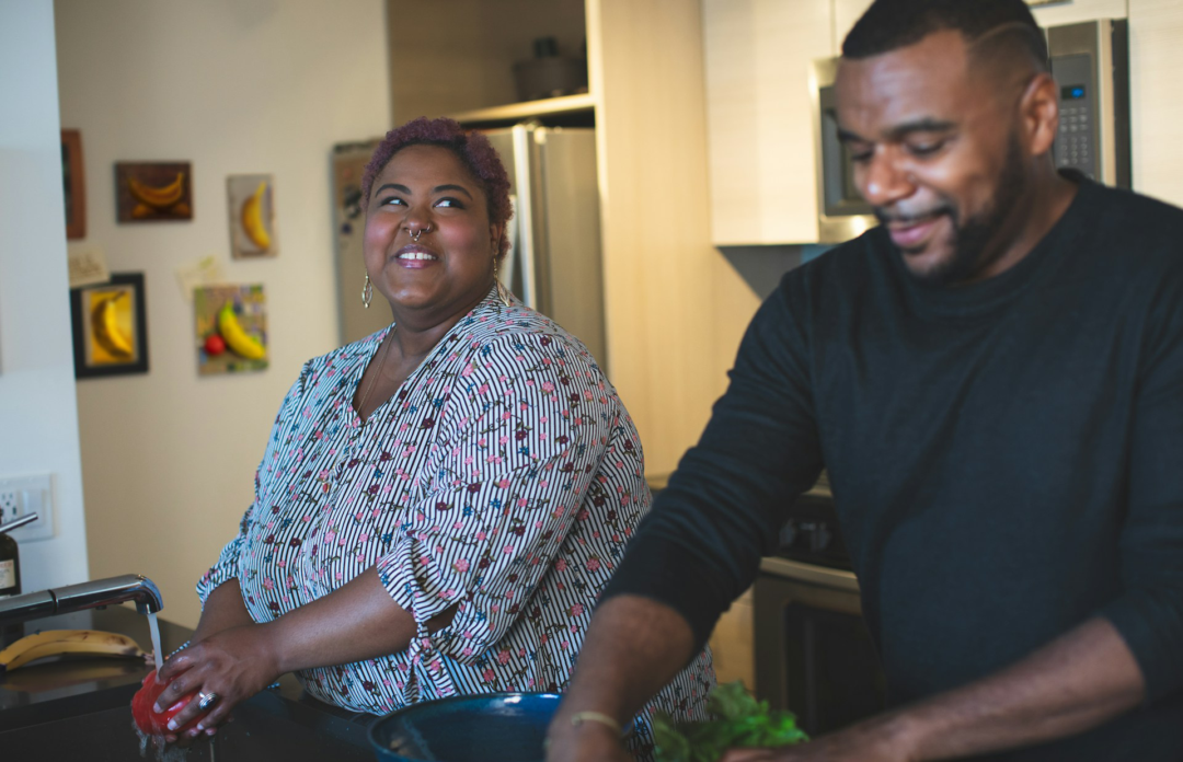 A banana looks on worryingly as a couple prepare a meal.