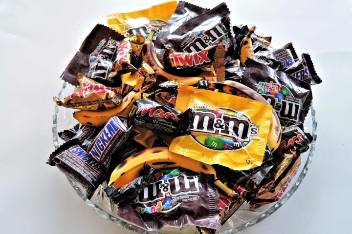 A bowl of Halloween candy, mixed in with bananas.