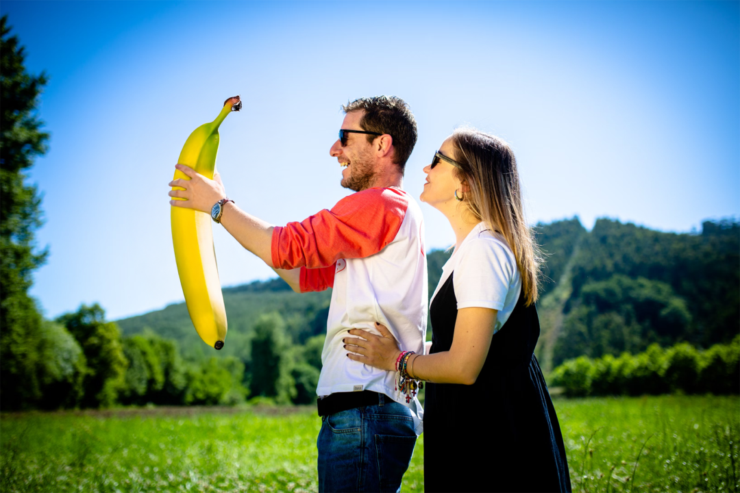 Bundle Of Joy Two proud parents hold up their banana baby.