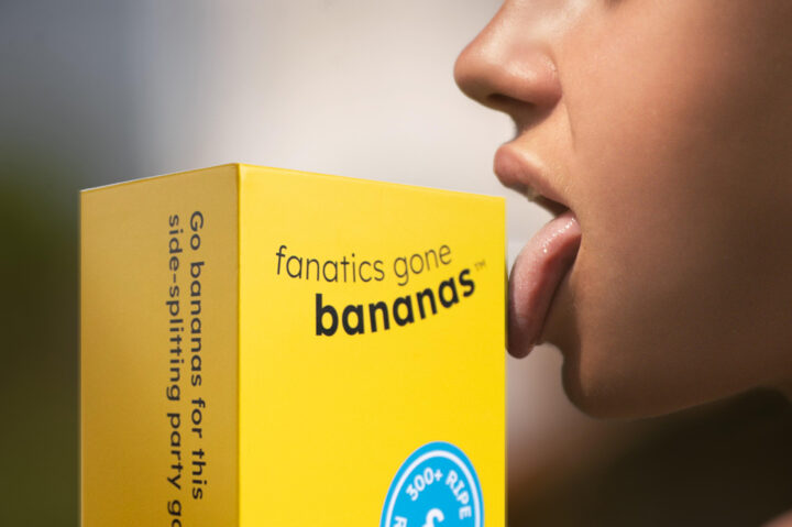 A lady seductively takes a taste of a Fanatics Gone Bananas box.