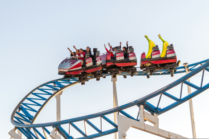 Two bananas join a group of riders on a rollercoaster and feel the wind in their peel.